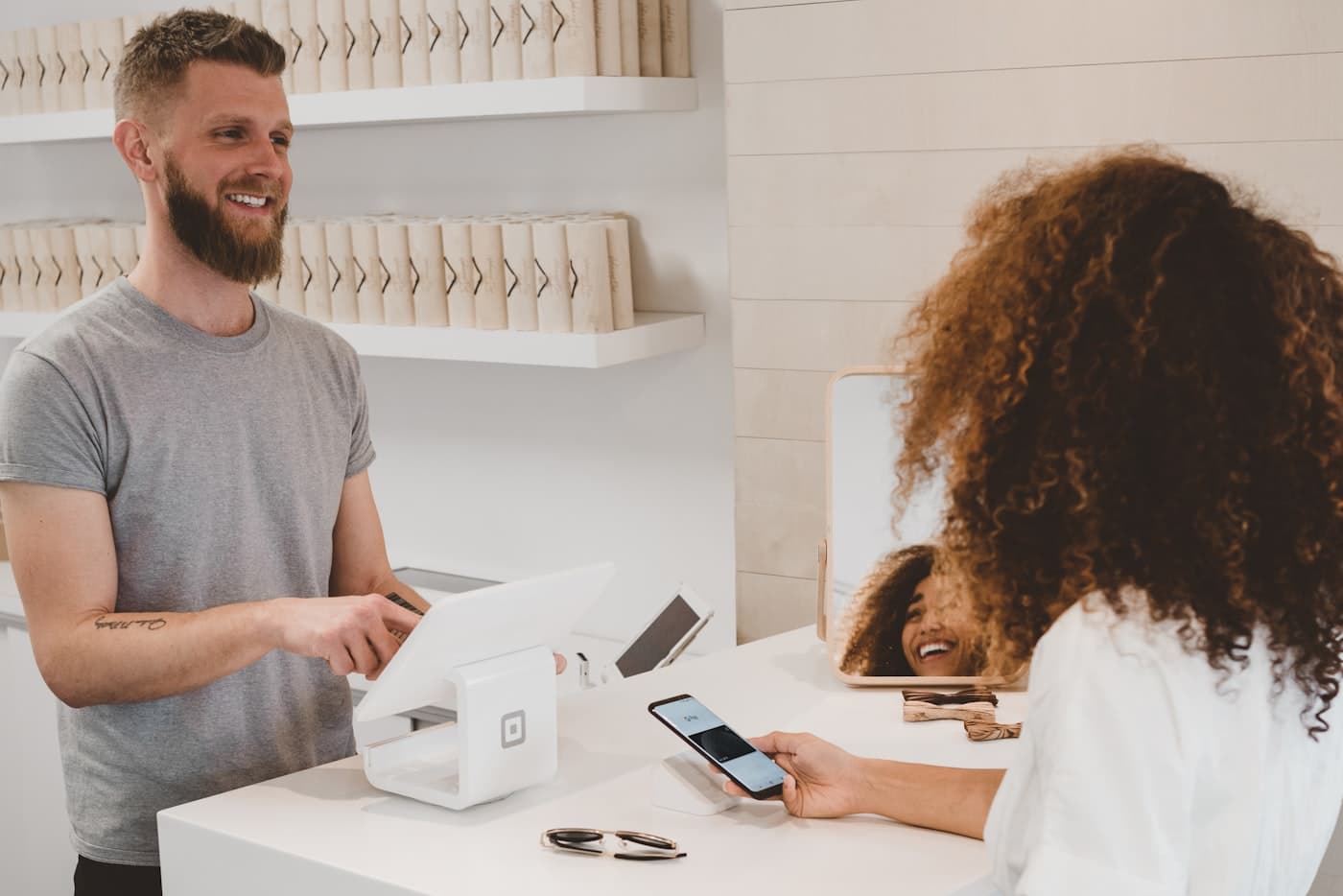 Customer paying at a shop counter with a card terminal