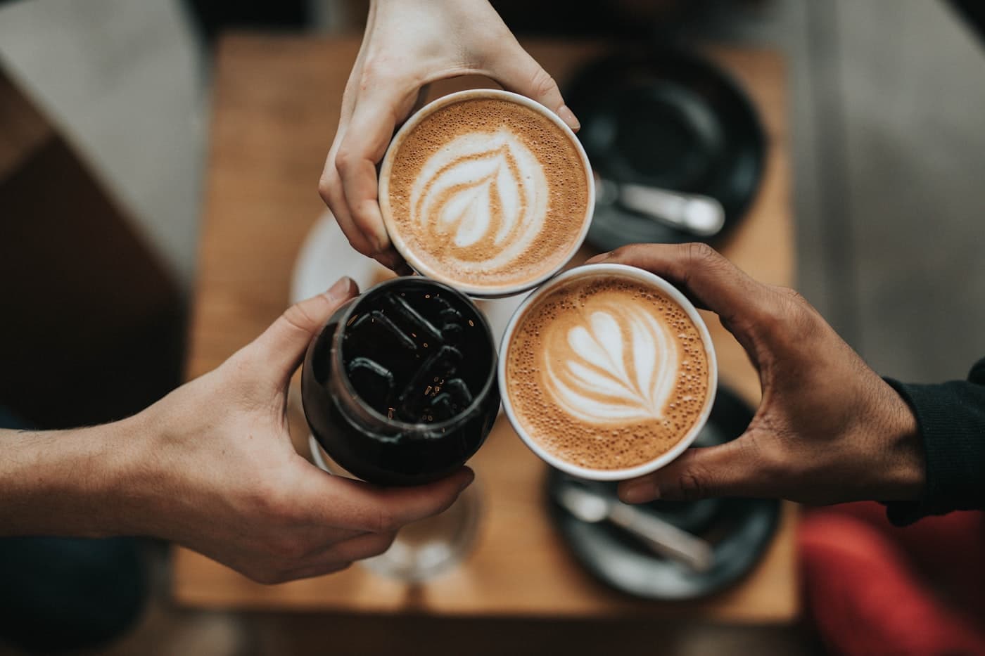 Barista handing a takeaway coffee across a cafe counter
