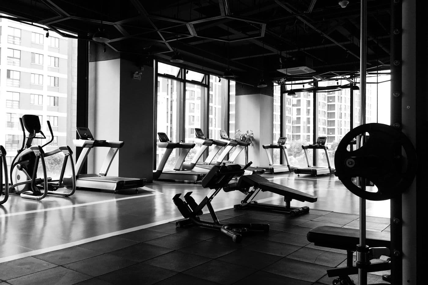 Warehouse-style gym interior with large windows, typical of the converted industrial units in Al Quoz