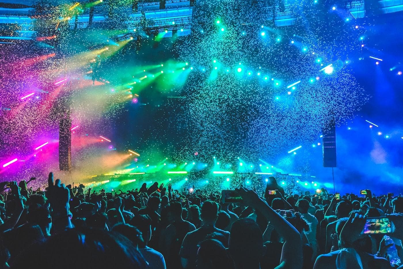 Crowd at an entertainment venue under colourful stage lighting