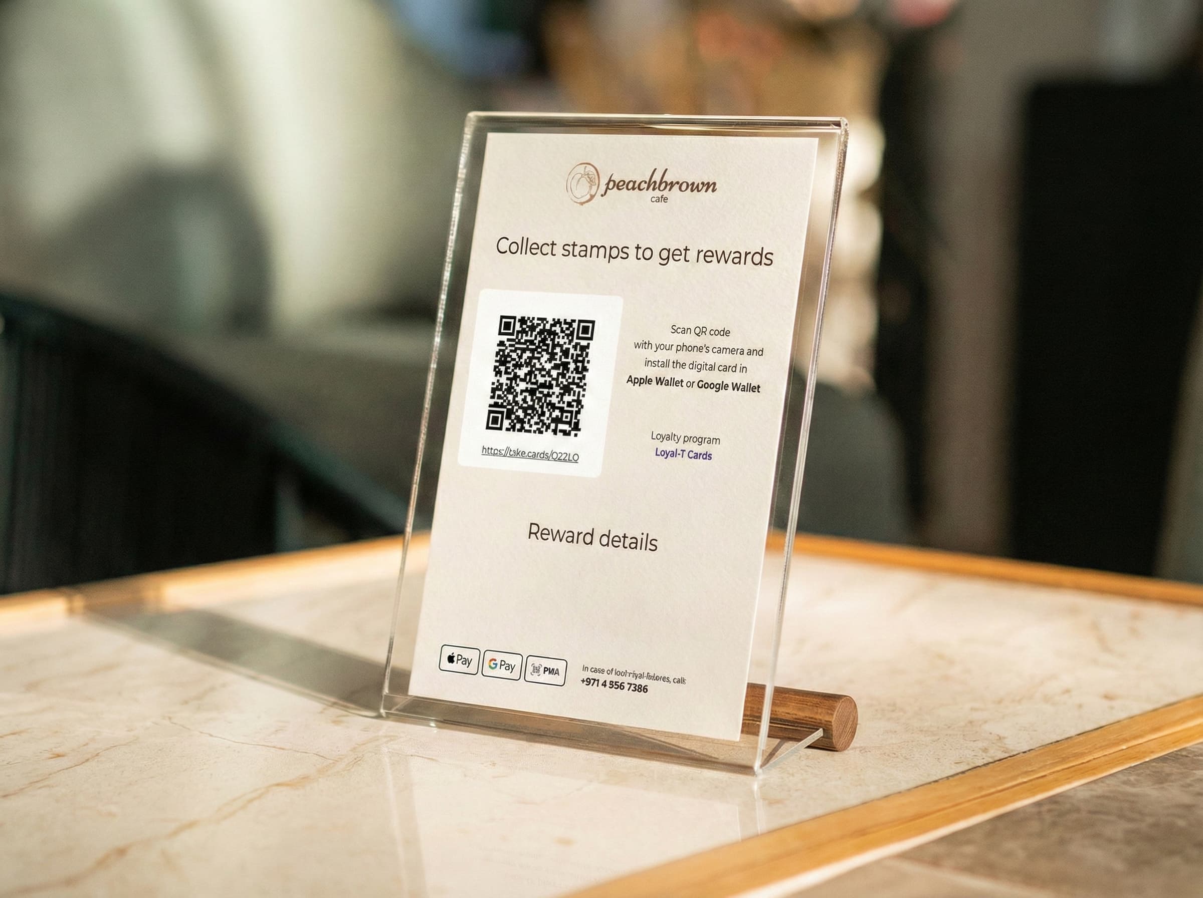 Peachbrown Cafe QR stand on a marble counter inviting customers to collect stamps and add the loyalty card to Apple Wallet or Google Wallet
