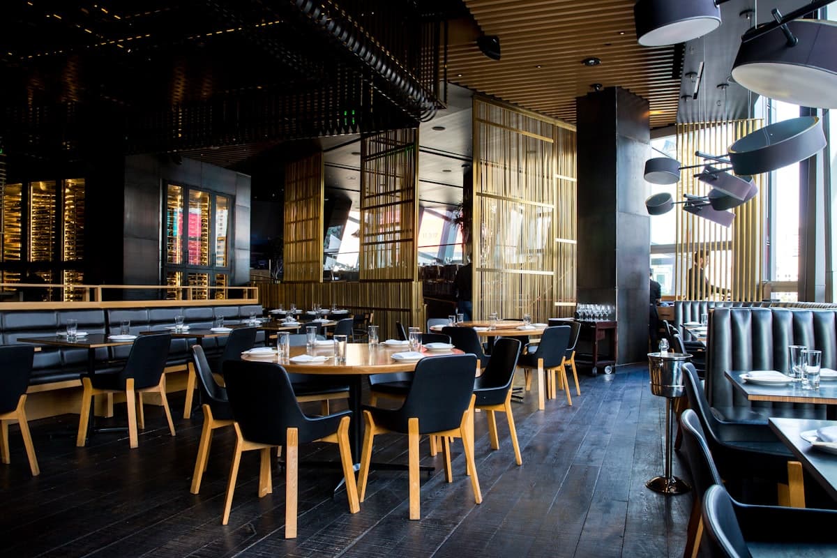 Restaurant interior with warm lighting and set tables